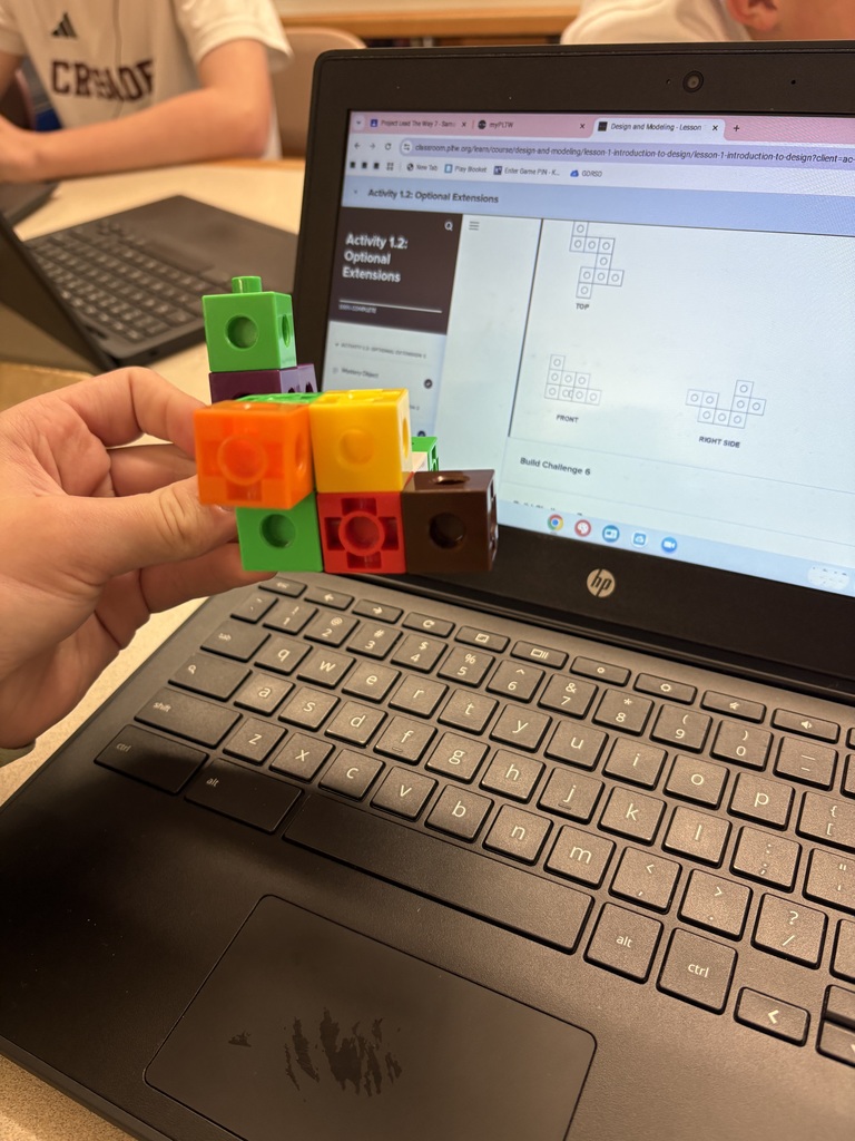 Students are interpreting view drawings to create their shapes.