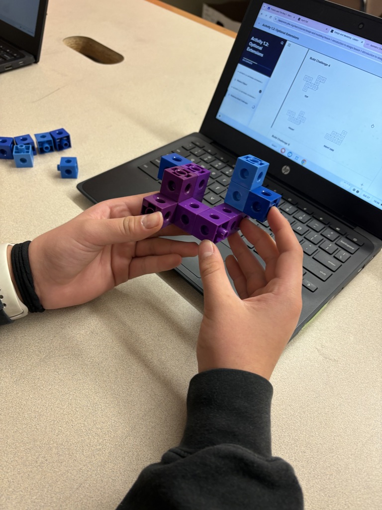 Students are interpreting view drawings to create their shapes.