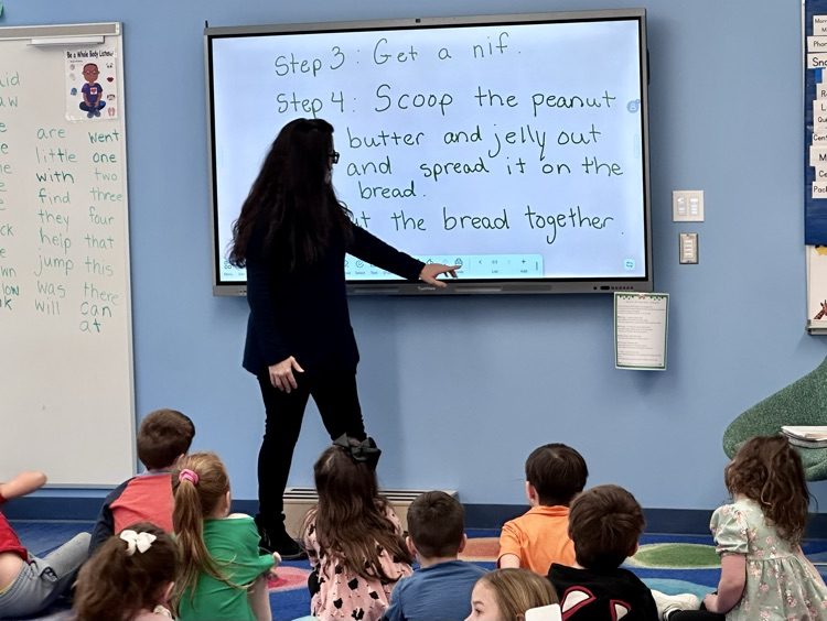 Mrs mulligan working on the interactive teaching panel