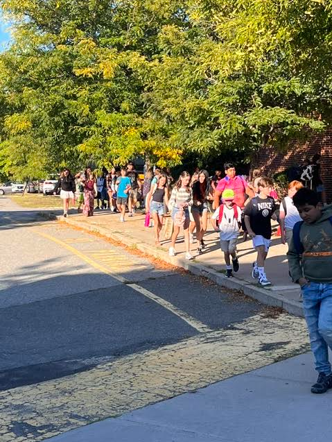 Photo of students filing into the building on the first day of school