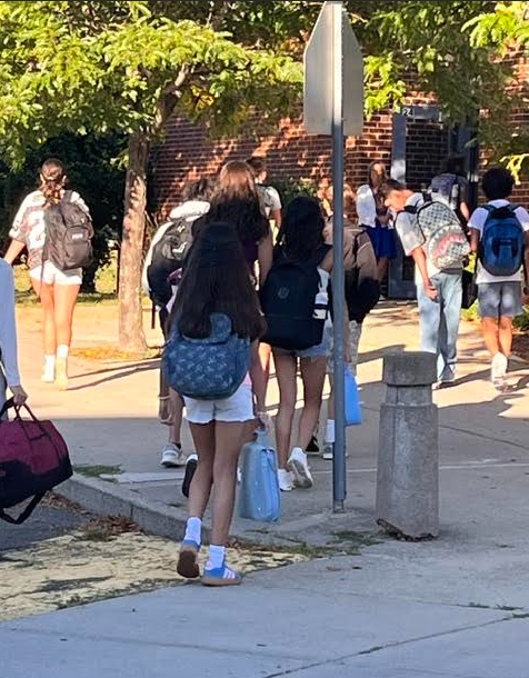 Photo of students filing into the building on the first day of school
