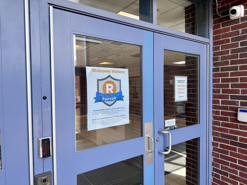 picture of the front door with a raptor visitor poster