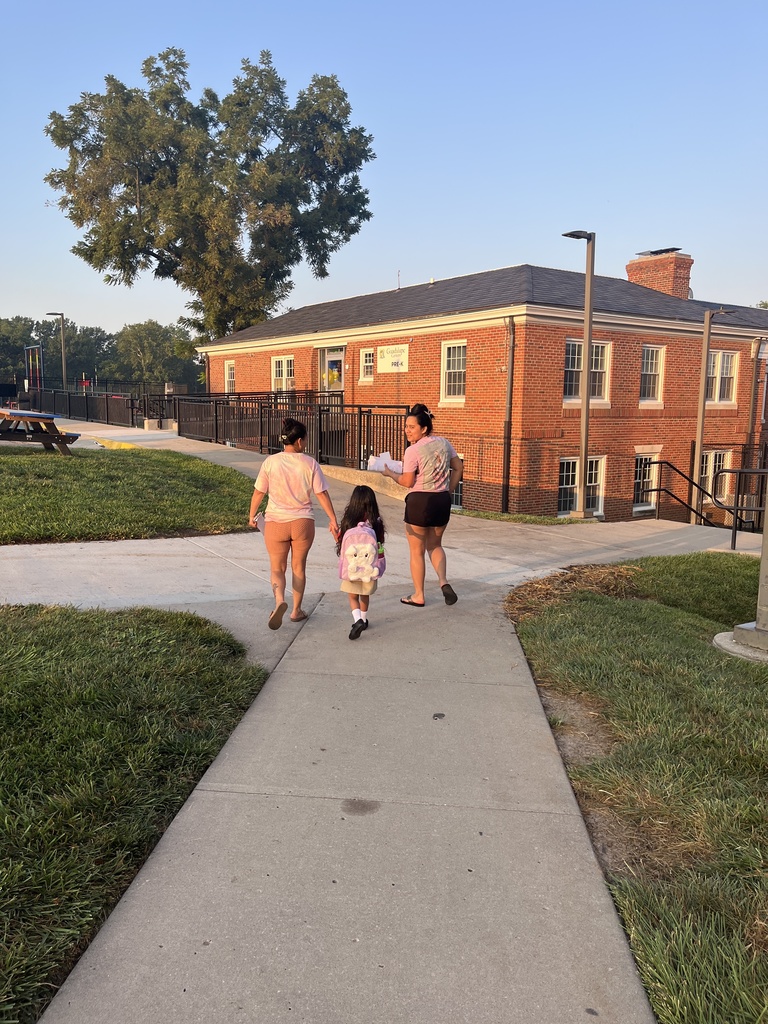 parents and student walking towards the school 