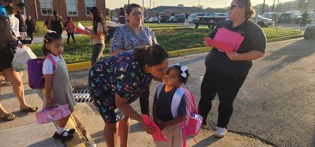 Mom hugging her daughter on the first day of school