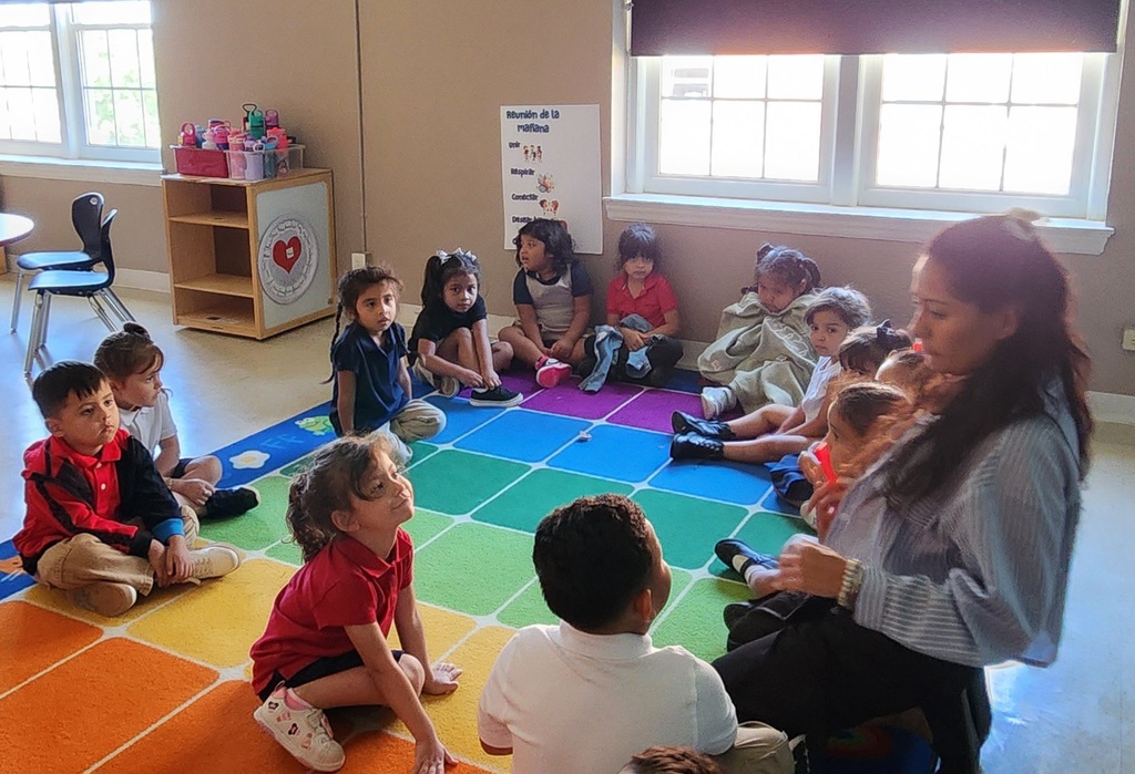 Teacher playing with her students