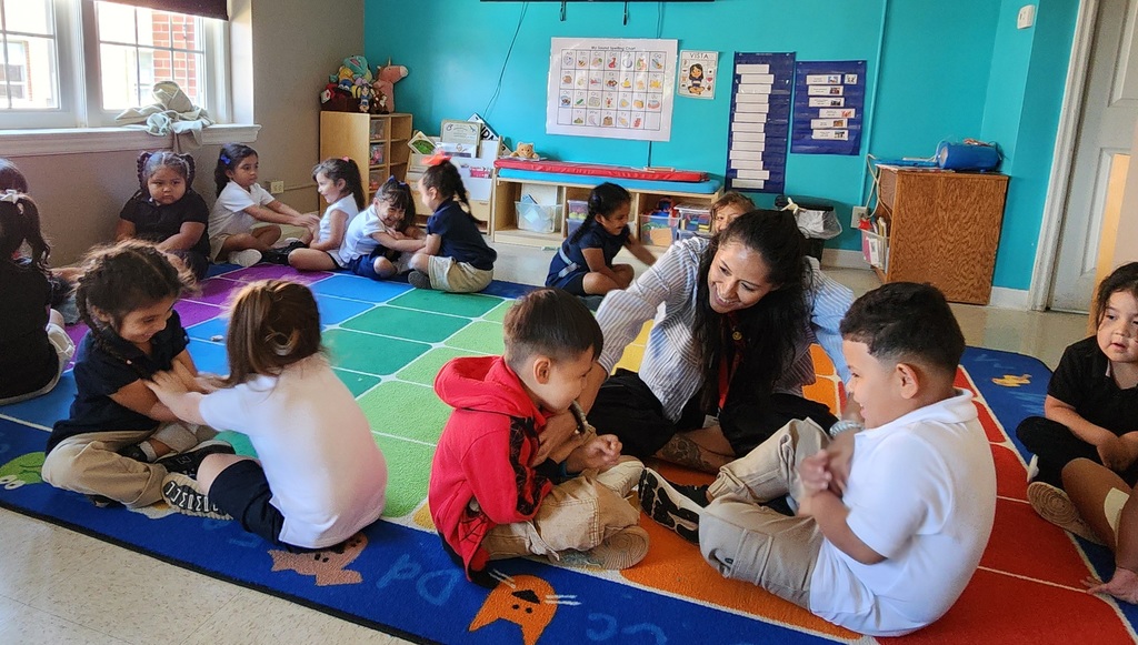 teacher playing with her students