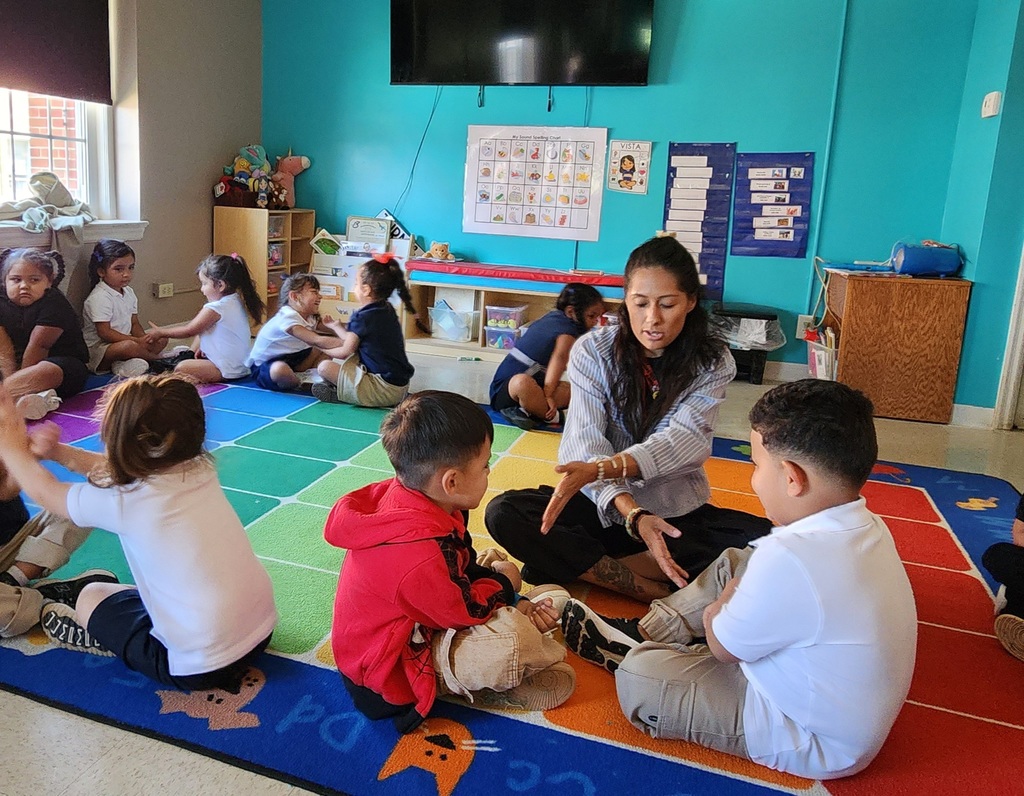 Teacher and children in the classroom playing