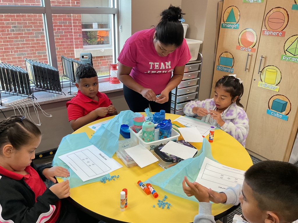 Mom doing a craft in the classroom.