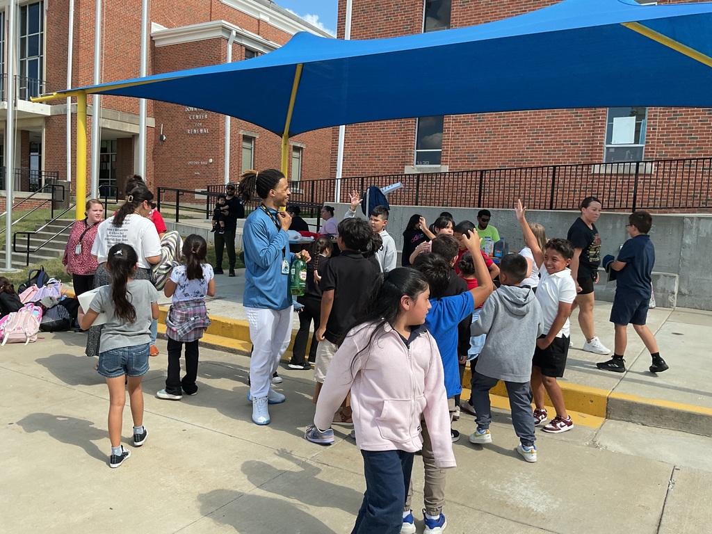 Teachers, students, and families enjoying a tea party.