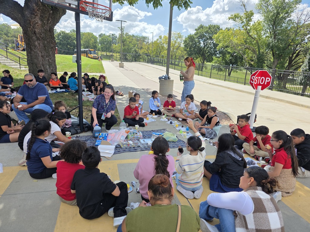 Teachers, students, and families enjoying a tea party.