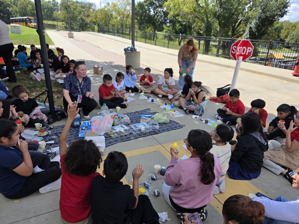 Teachers, students, and families enjoying a tea party.