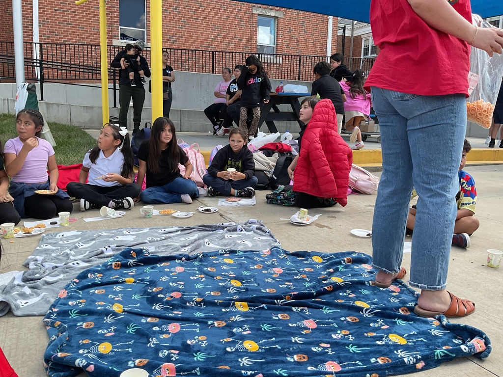 Teachers, students, and families enjoying a tea party.