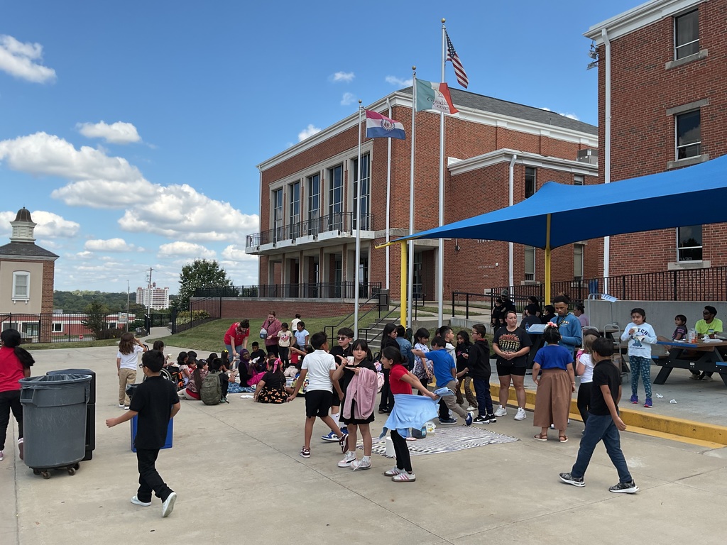 Teachers, students, and families enjoying a tea party.