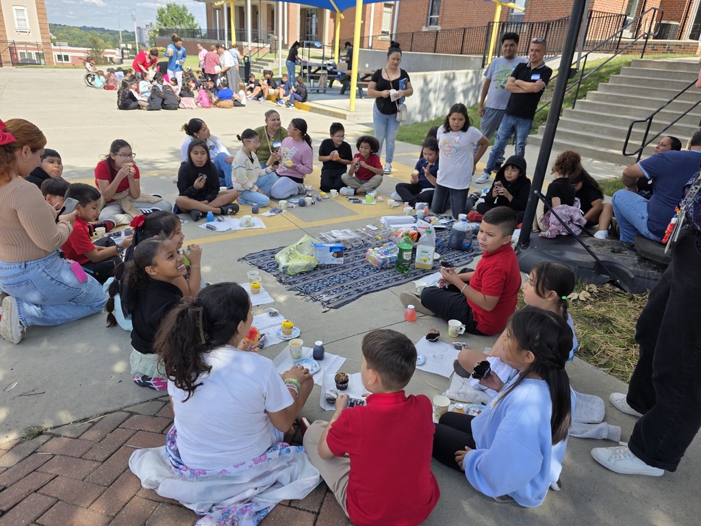 Teachers, students, and families enjoying a tea party.