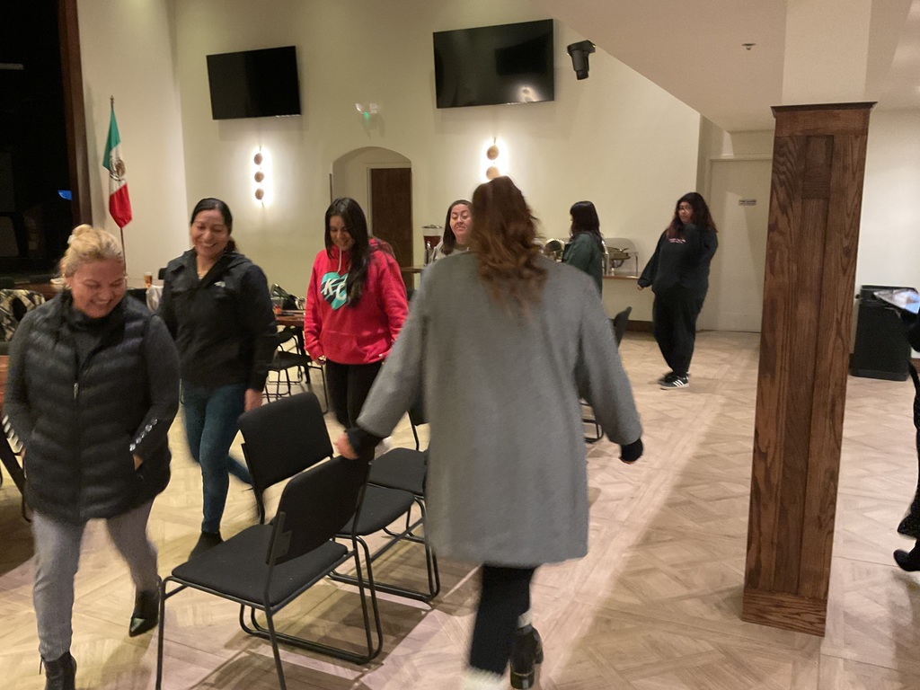 Parent volunteers playing musical chairs