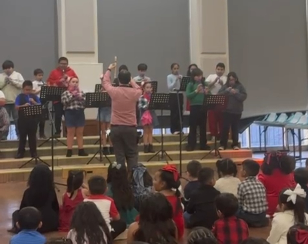 Music teacher directing their students.