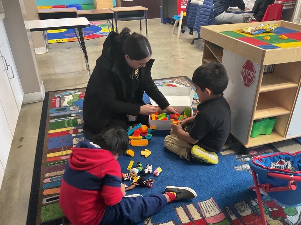 A teacher playing with a child in the classroom