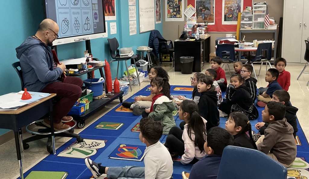 eacher in art class teaching painting techniques