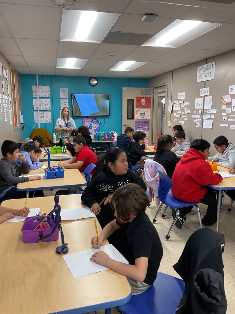 eacher in art class teaching painting techniques