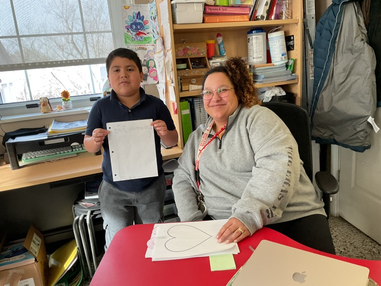 counselor and student showing off work