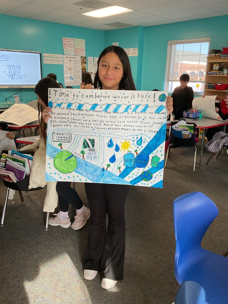 student showing off their poster