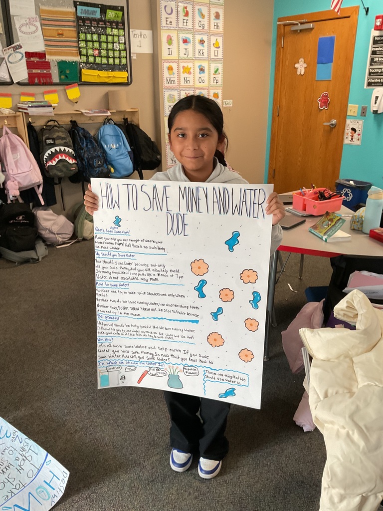 student showing off their poster