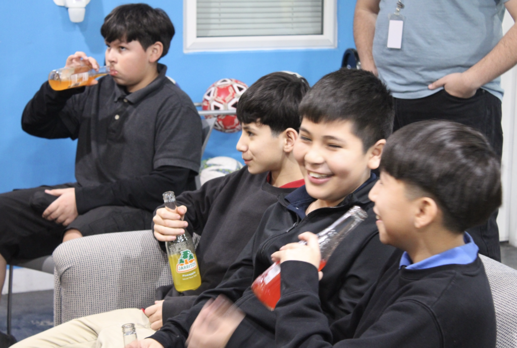 student laughing and enjoying a drink during workshop