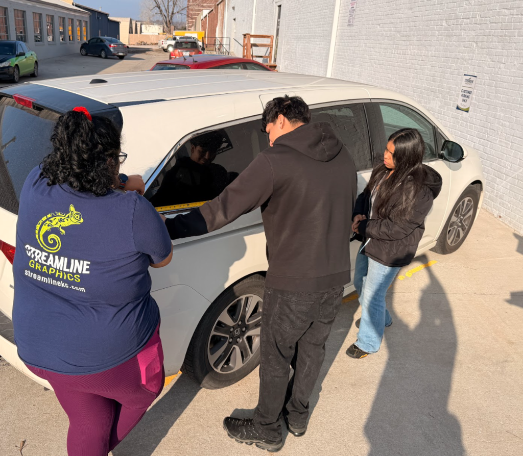 Student measuring a van for project