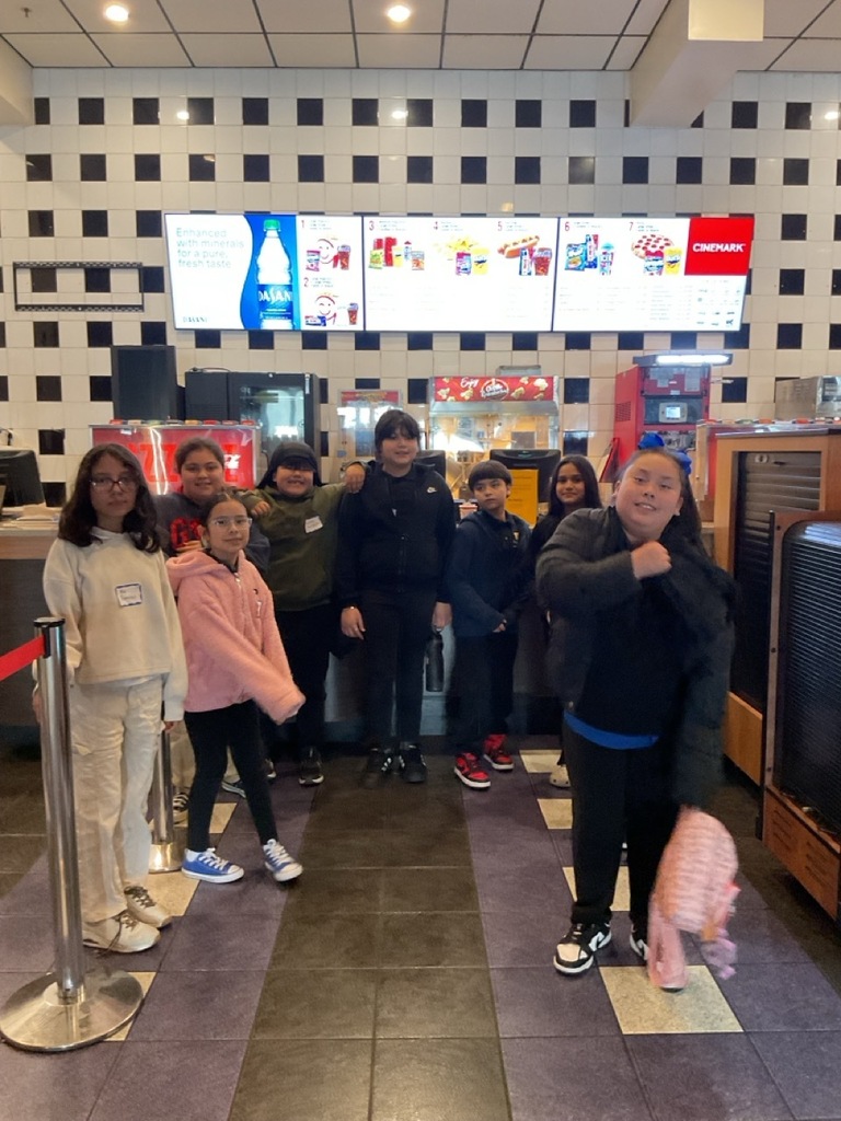 Group of children posing for a photo at the movie theater.