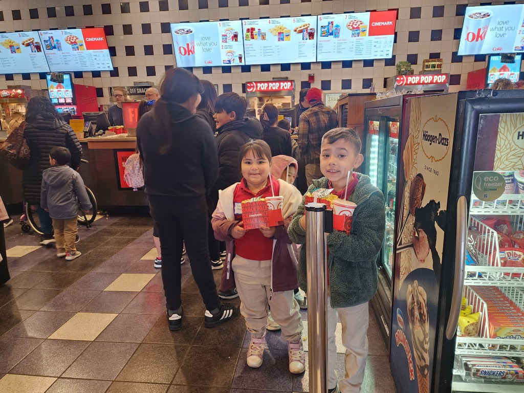 Boy and girl happy because they are going to the movies with their schoolmates.