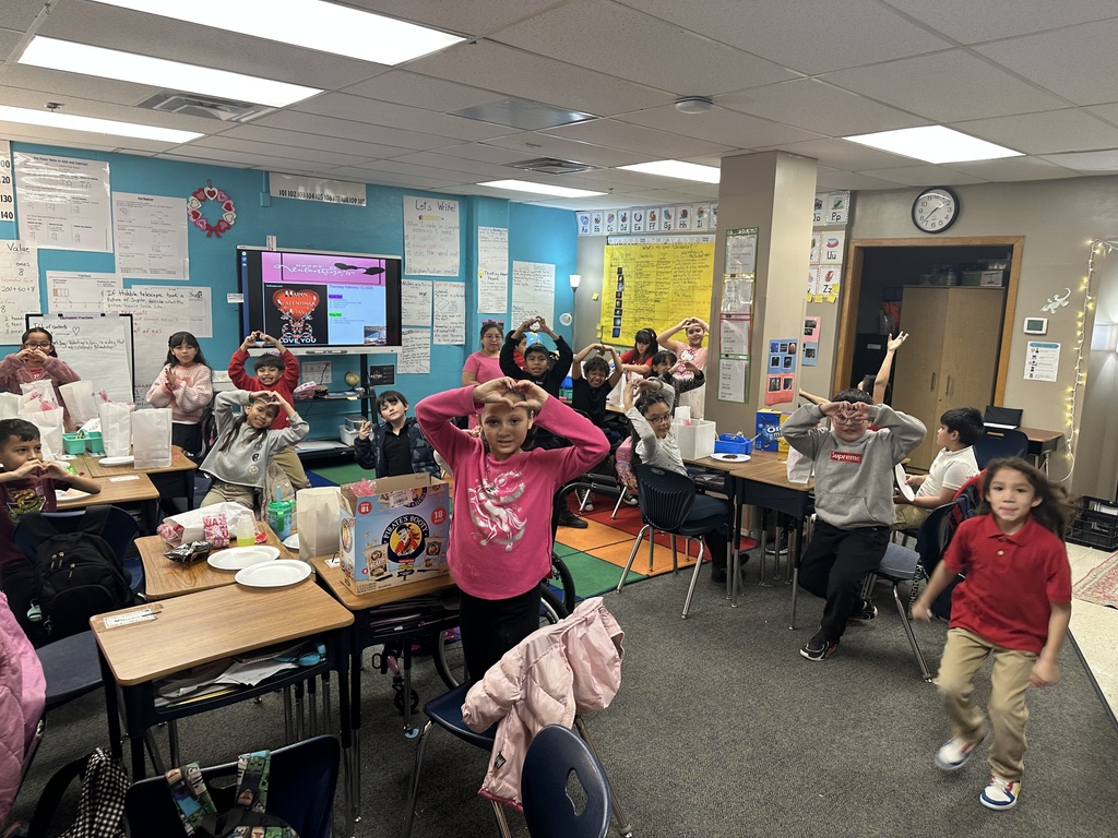 Third grade group celebrating the Friendship Party dressed in pink and red