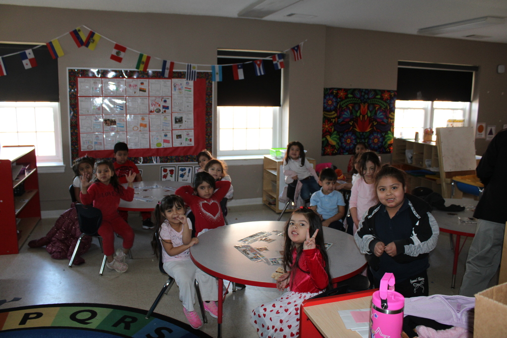 Pre-K children posing for a photo before enjoying cupcakes at their Friendship Party celebration