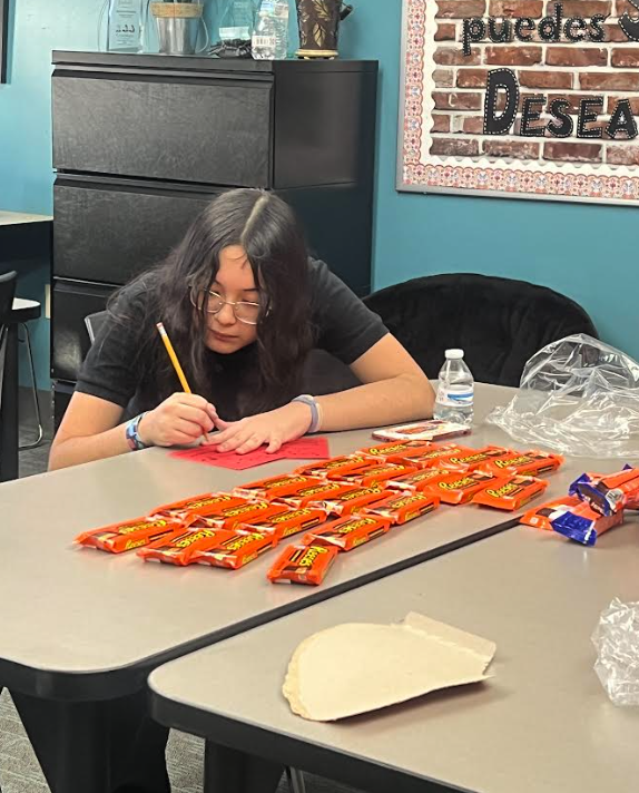 student writing on a vday gram