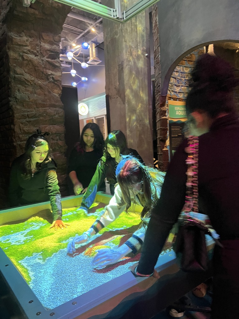 students touching magic sand
