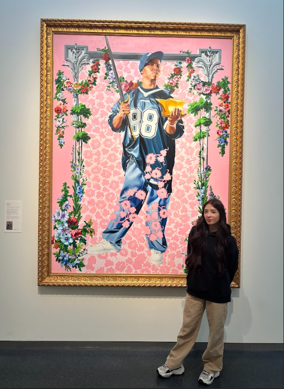 student in front of a painting