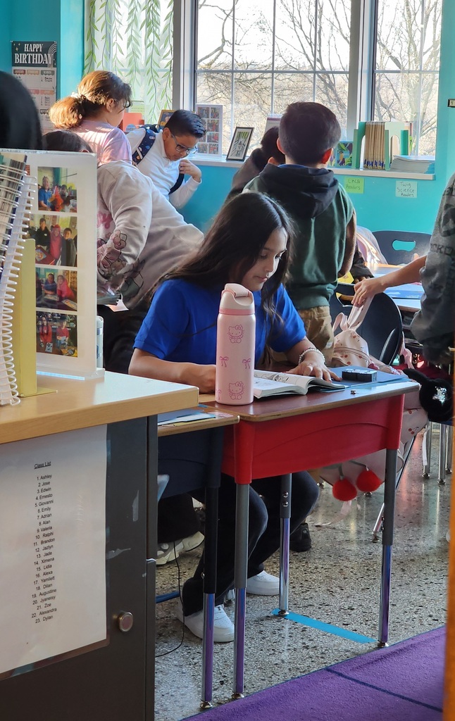 A student reading their favorite book , relaxed and happy.
