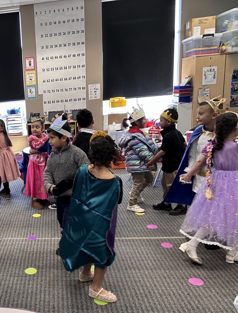 Kindergarten children dancing in pairs to a waltz, doing a classroom activity about royalty