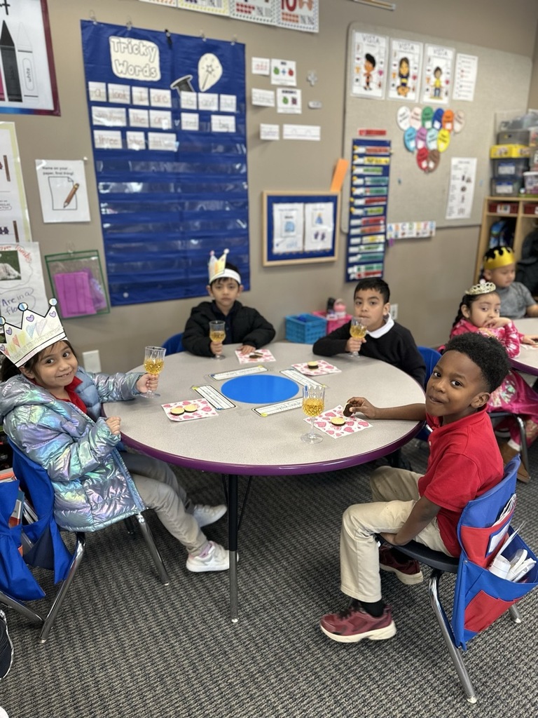 Kindergarten children making a toast with their classmates as part of a royalty-themed activity