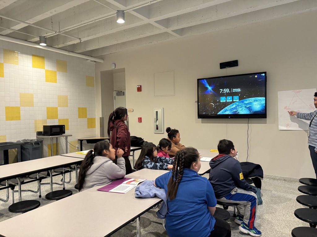 Students sitting looking at the board.