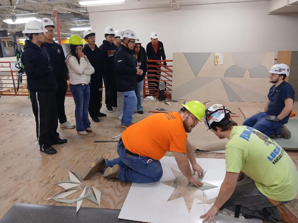 group of students looking at carpenters work 