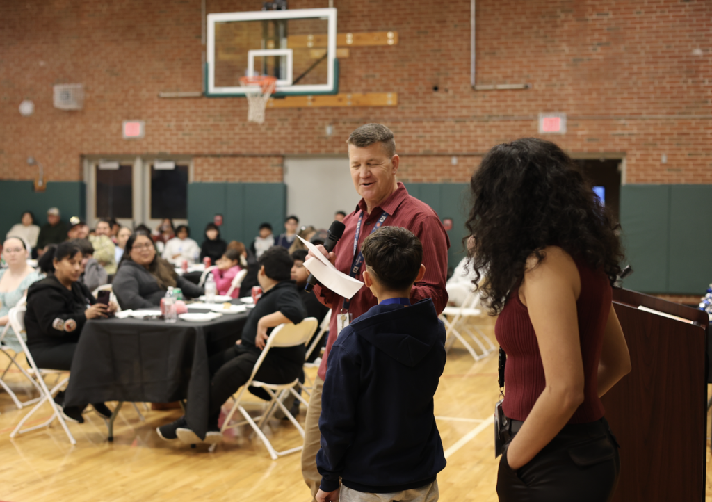 Mr. Seibold giving a certificate to a student