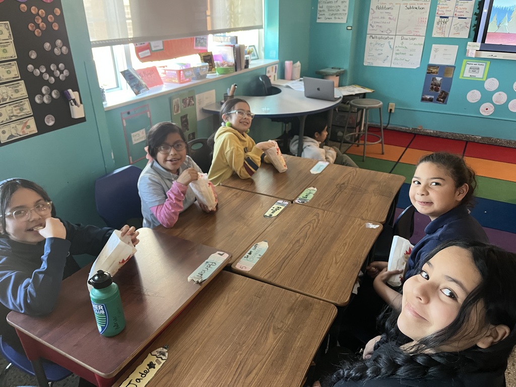 Children in their classroom eating popcorn — they were among the classes with the best attendance and received a popcorn party.