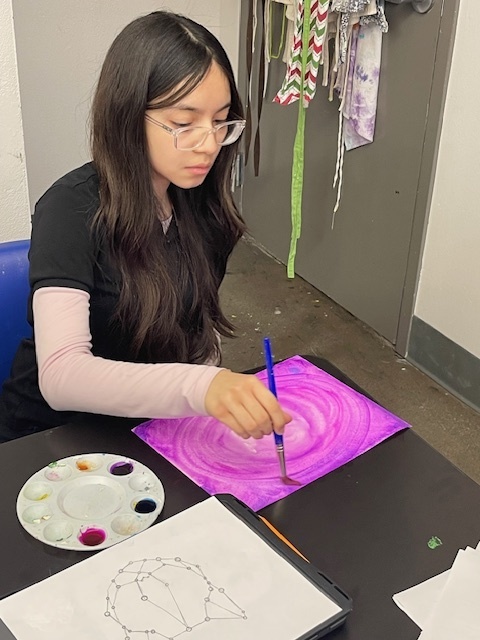 student creating a masterpiece