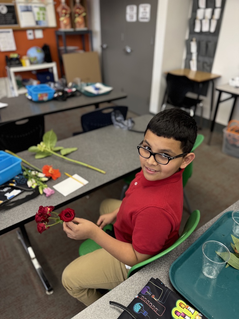 student holding a rose to draw