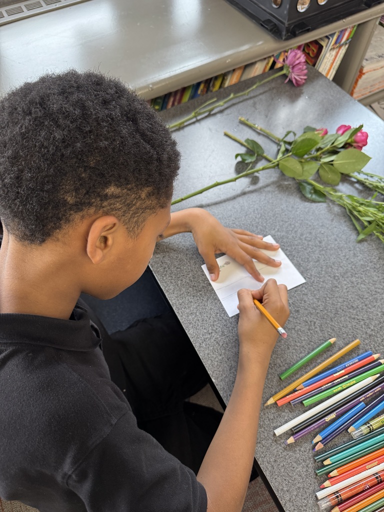 student drawing his flowers