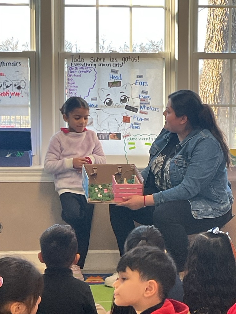 A Pre-K student, with her teacher, shared what she learned about horses.