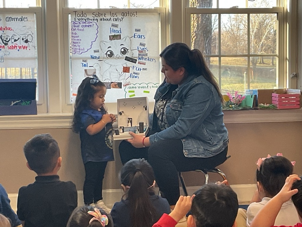 A Pre-K student, with her teacher, shared what she learned about penguins.