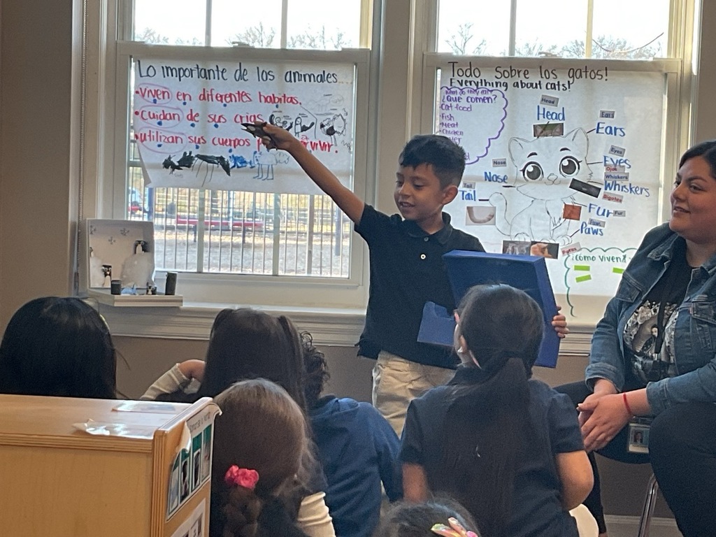 A Pre-K student, with his teacher, shared what she learned about sharps.