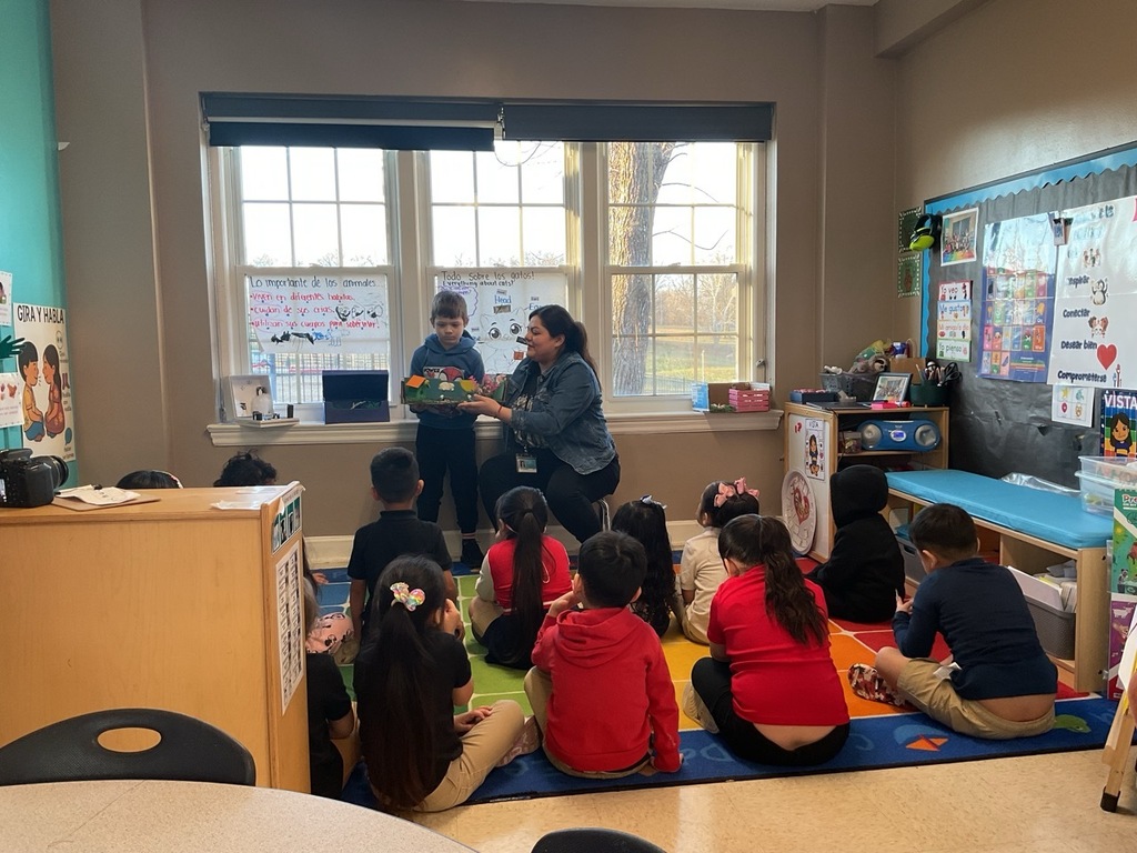 A Pre-K student, with his teacher, shared what she learned about birds.