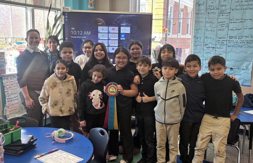 3rd grade classroom posing with ribbon